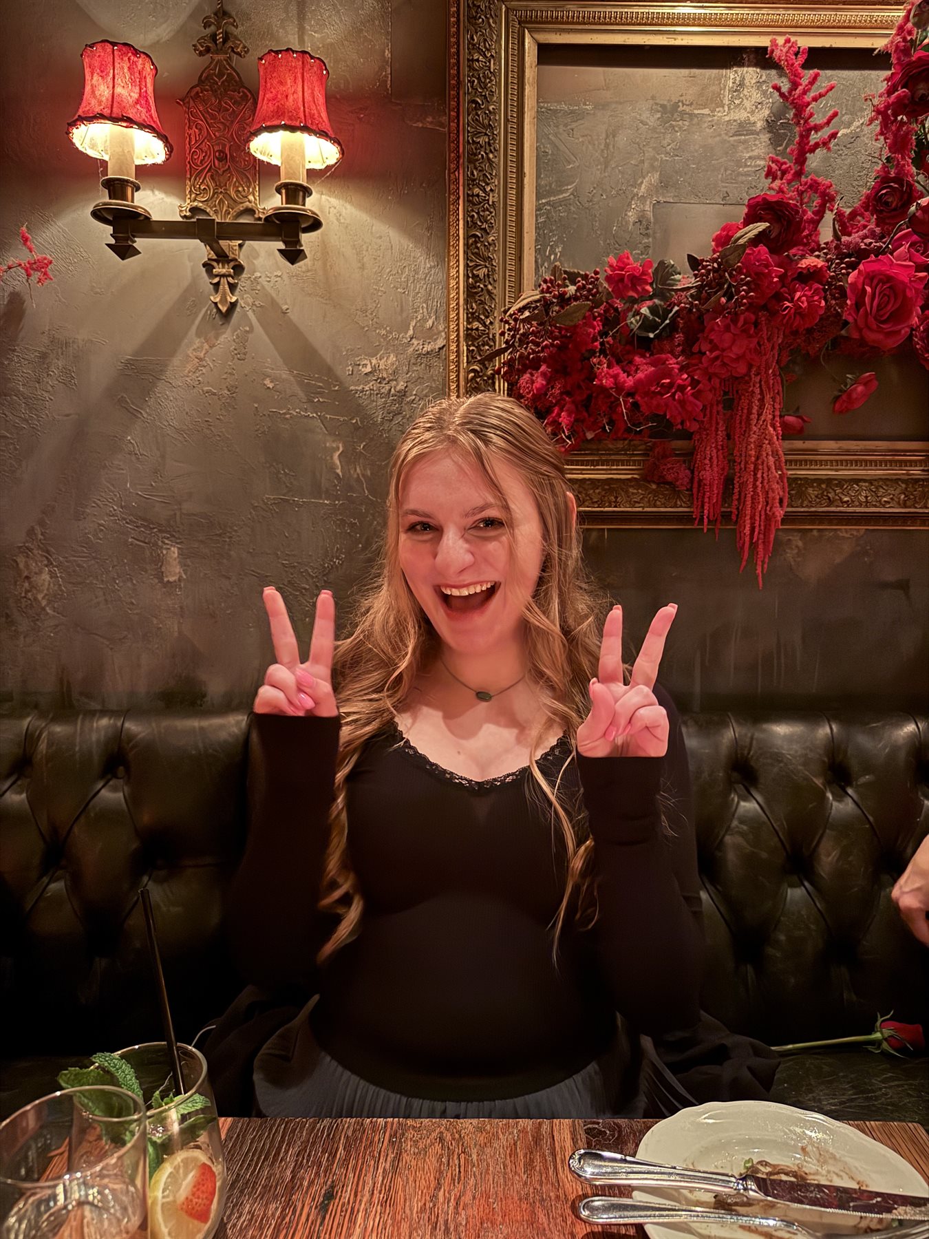 Allison flashing peace signs at a fancy dinner